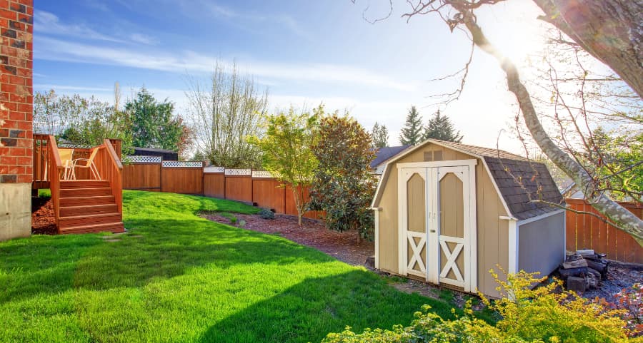 Fenced backyard with storage shed in Akron